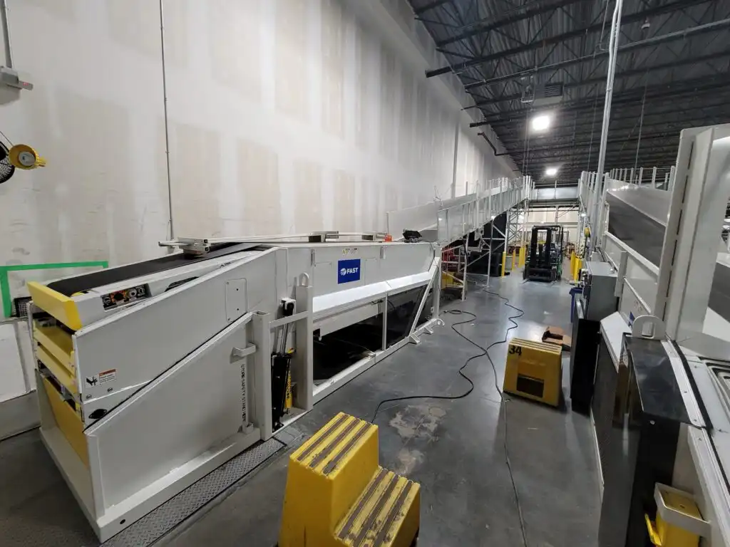 Industrial conveyor system extending through FedEx distribution warehouse